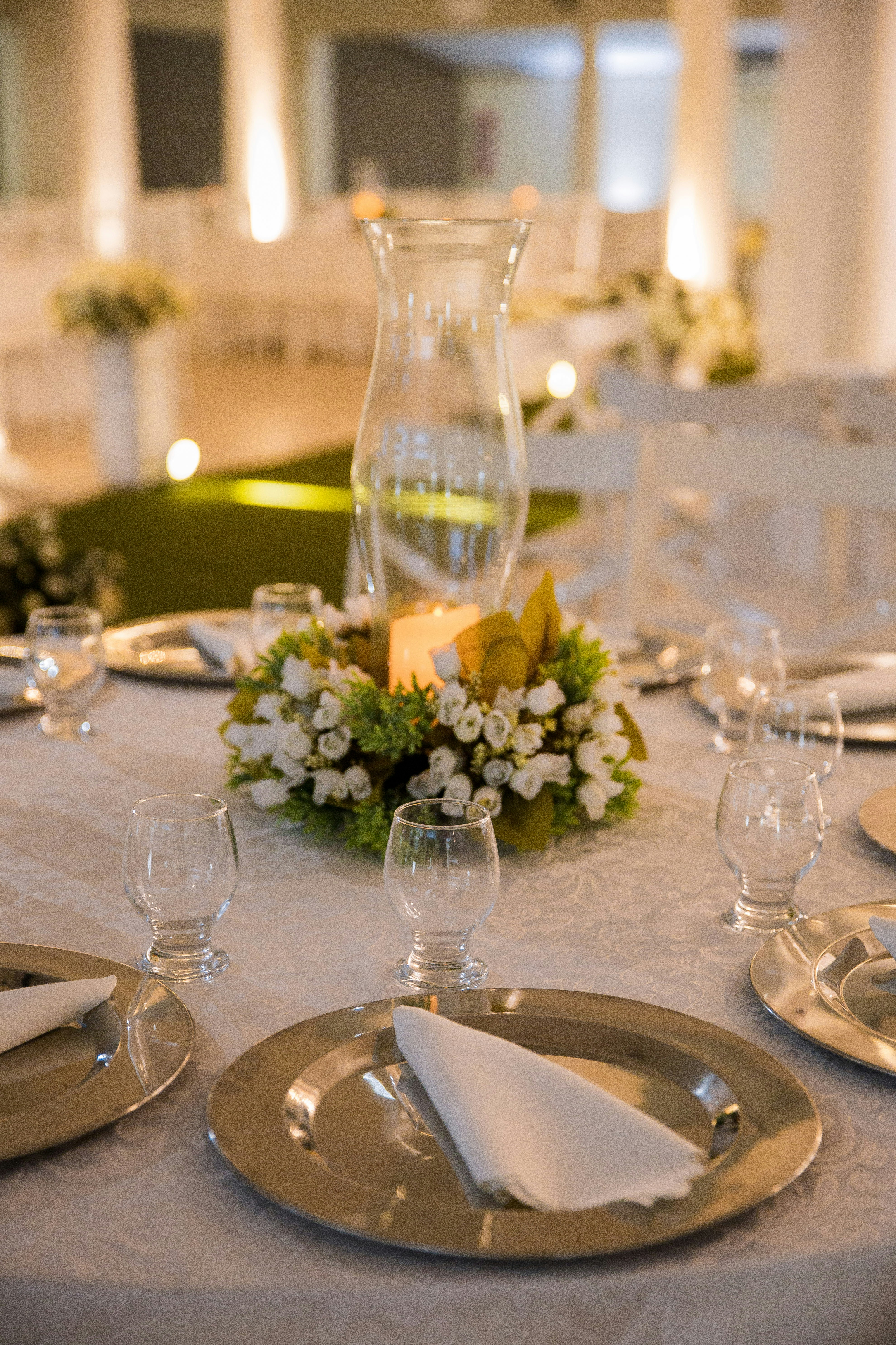 white flowers in clear glass vase on table
