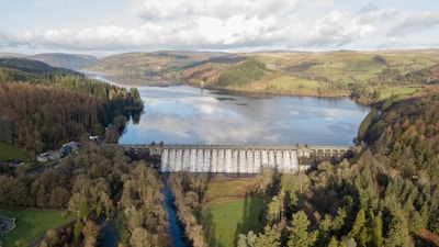 A large dam under construction in a scenic landscape.