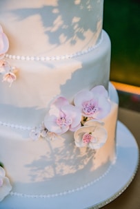An elegant wedding cake with floral decorations.