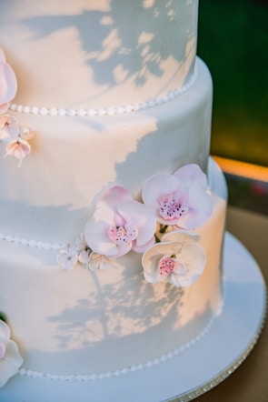 An elegant tiered wedding cake adorned with floral accents.