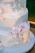 Elegant wedding cake adorned with pink and gold floral decorations from Maison Rosée.