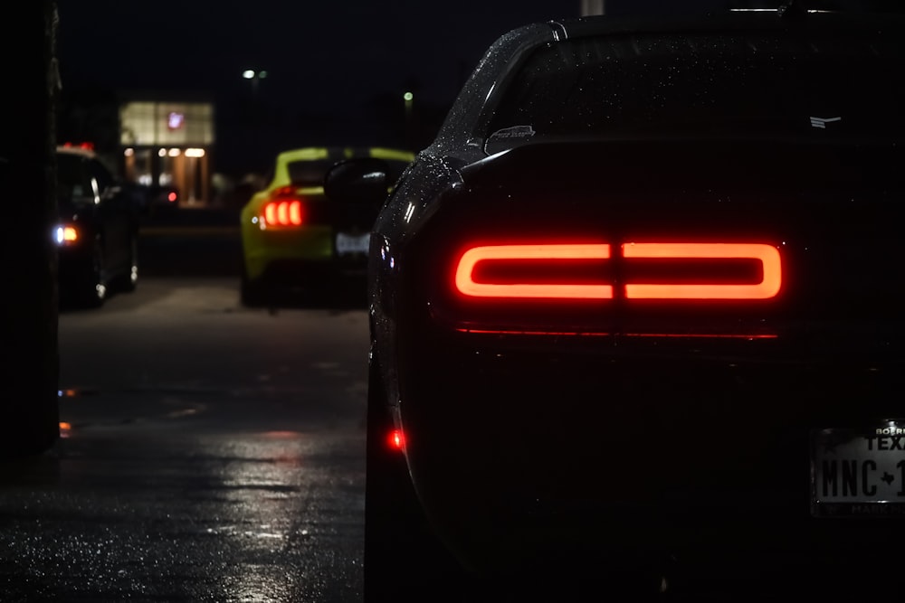 black car on road during night time