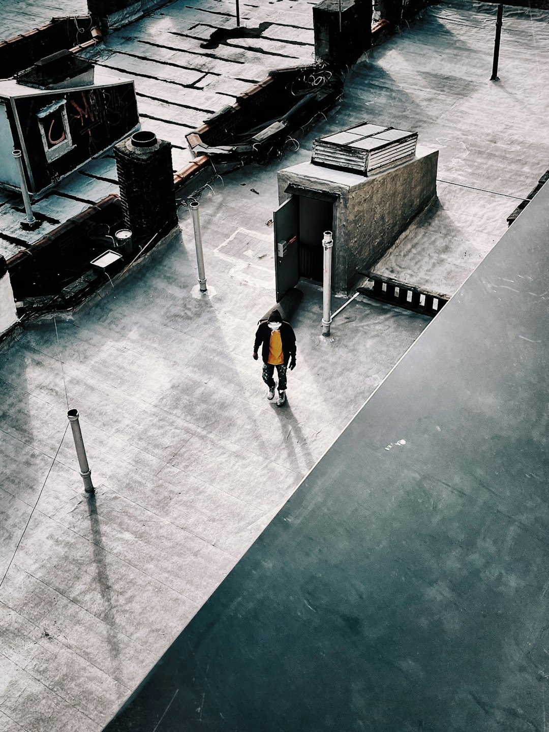 man in yellow shirt walking on sidewalk during daytime