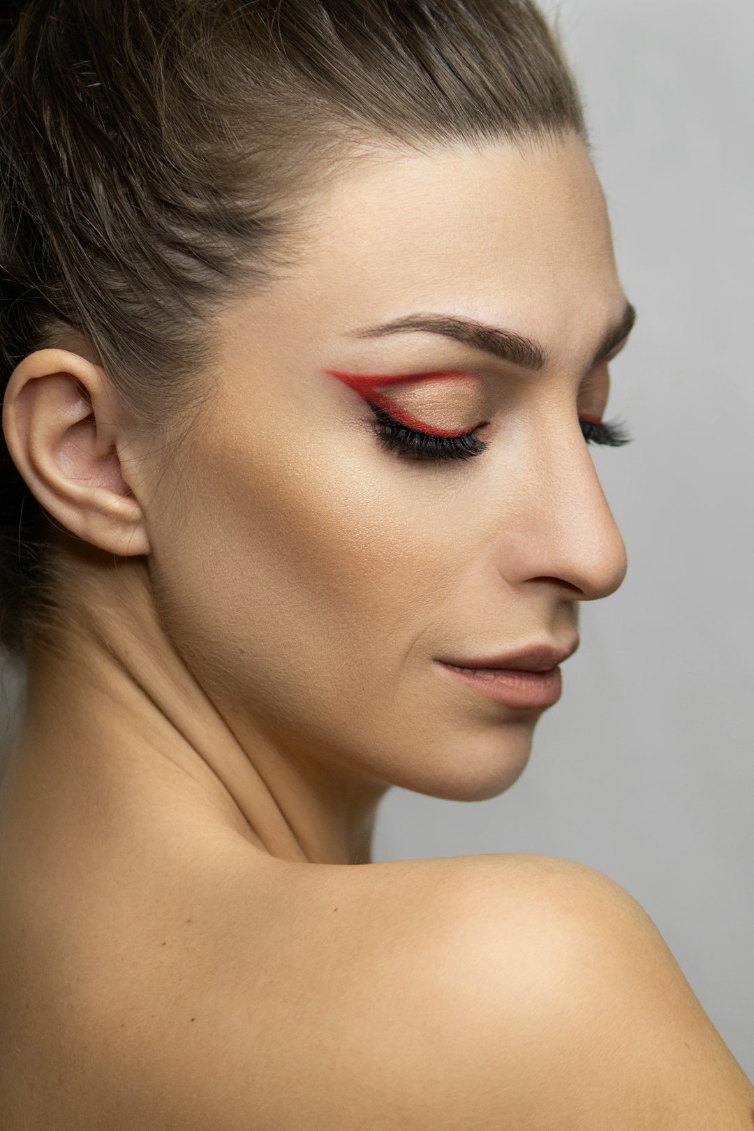 woman with red lipstick and black mascara