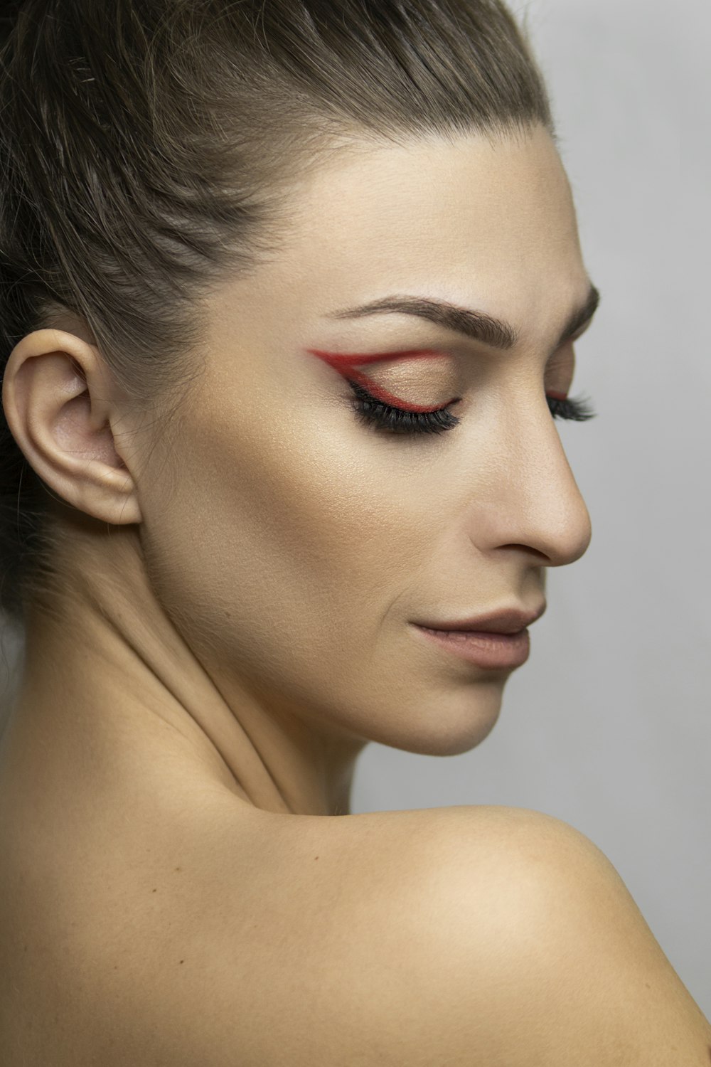 woman with red lipstick and black mascara