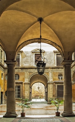 Elegant courtyard with black stone flooring and golden lanterns casting soft light.