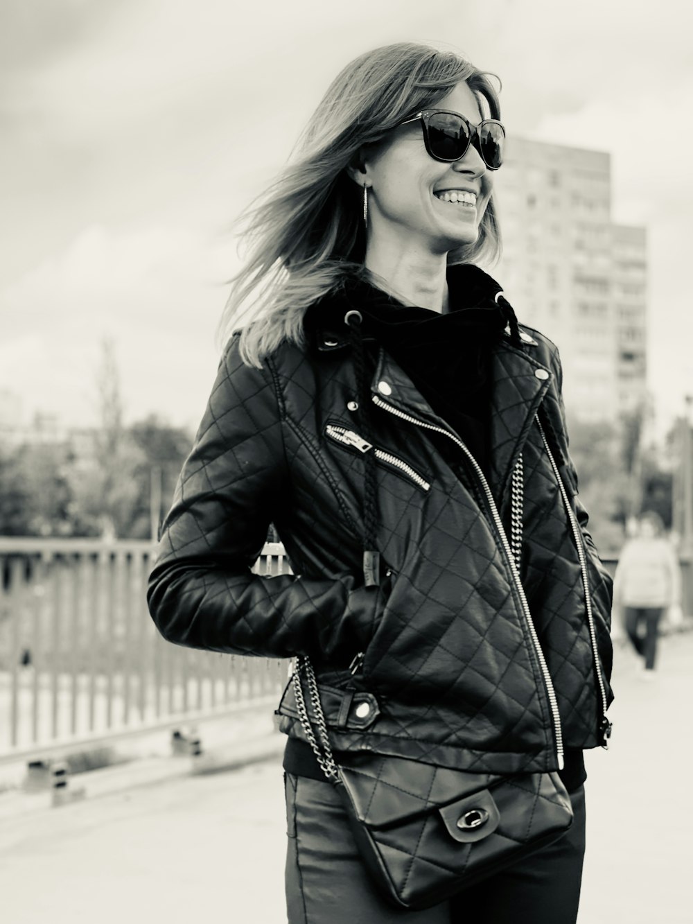 woman in black leather jacket wearing black sunglasses