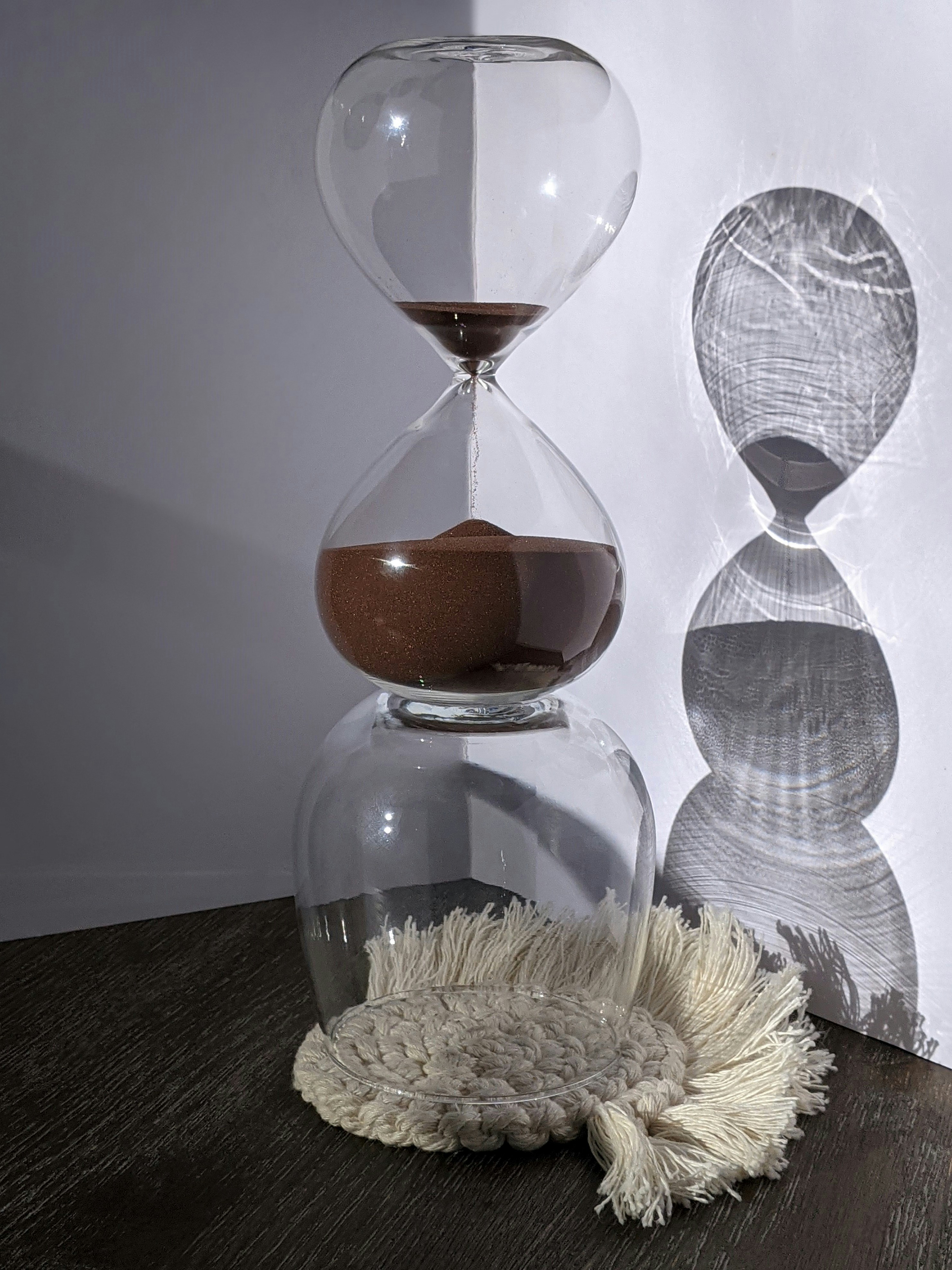 clear glass hour glass on black table