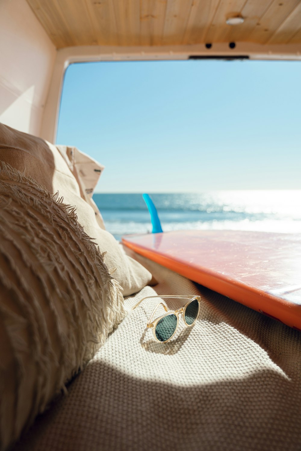 silver framed sunglasses on brown wooden table