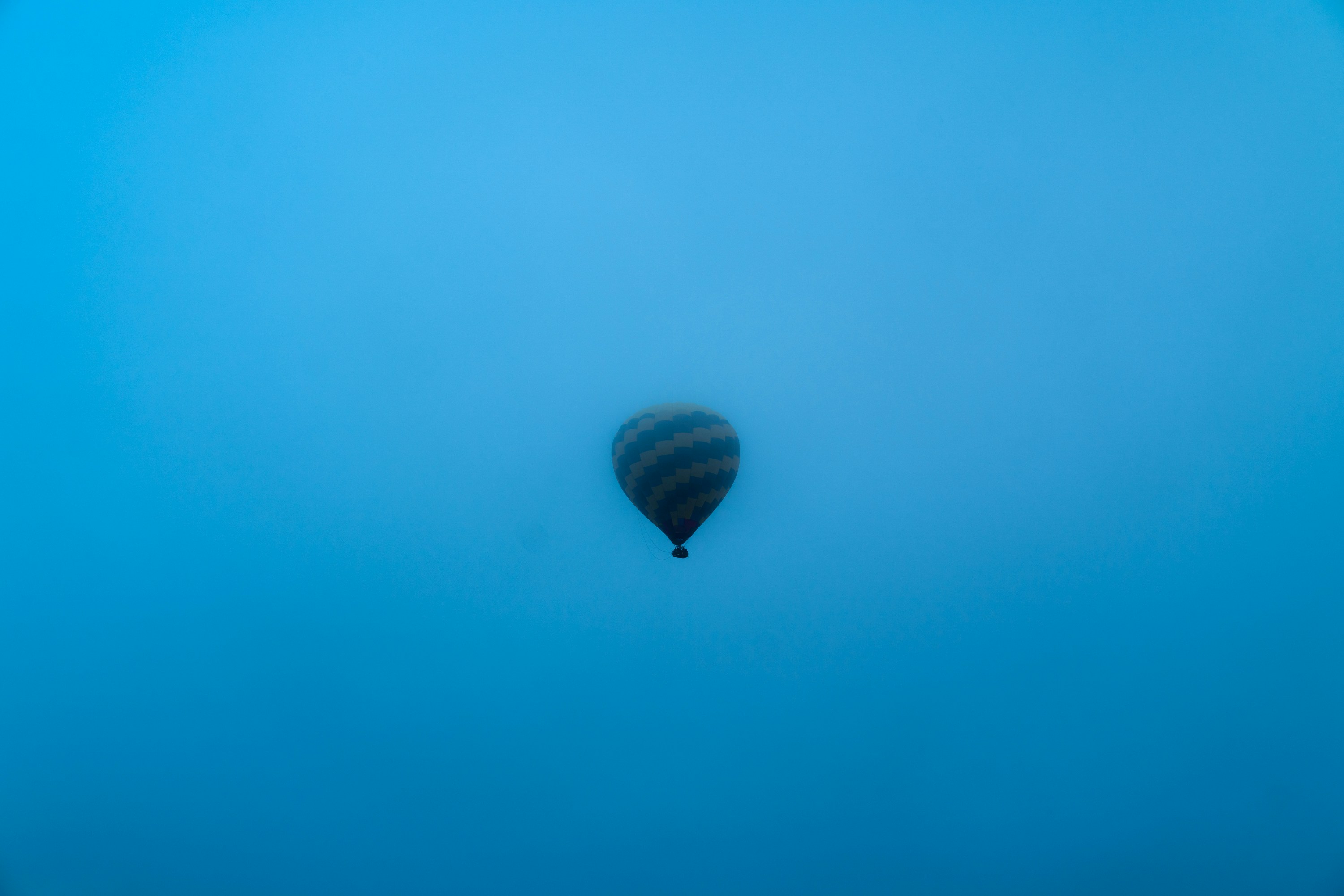 black hot air balloon in the sky