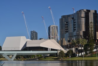 white and gray building near body of water during daytime