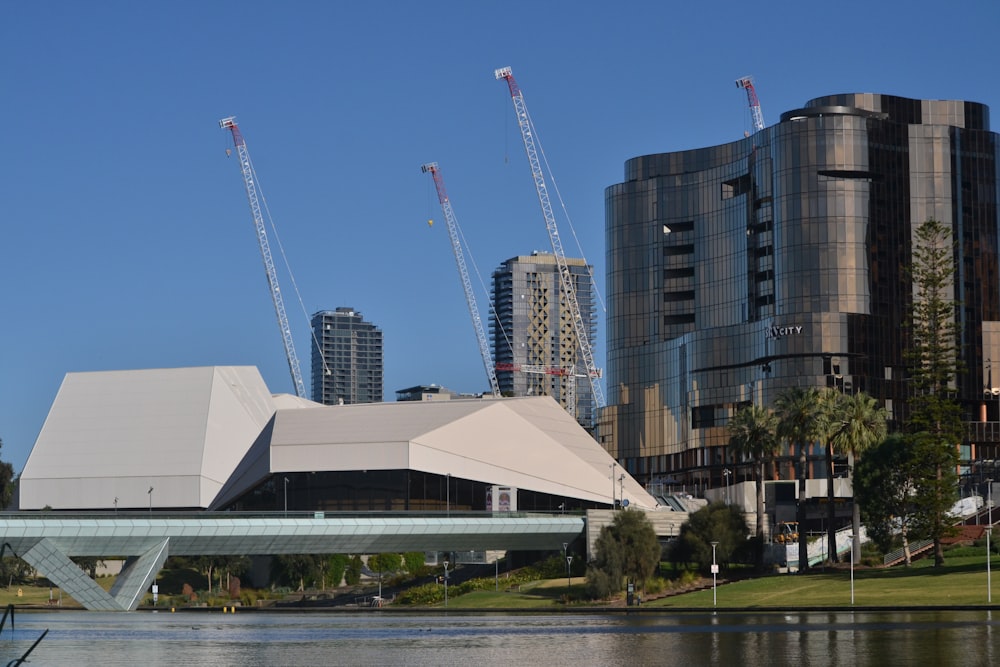 white and gray building near body of water during daytime