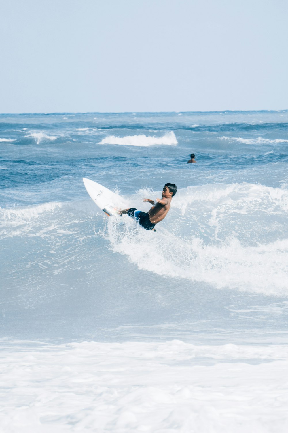 homme surfant sur les vagues de la mer pendant la journée