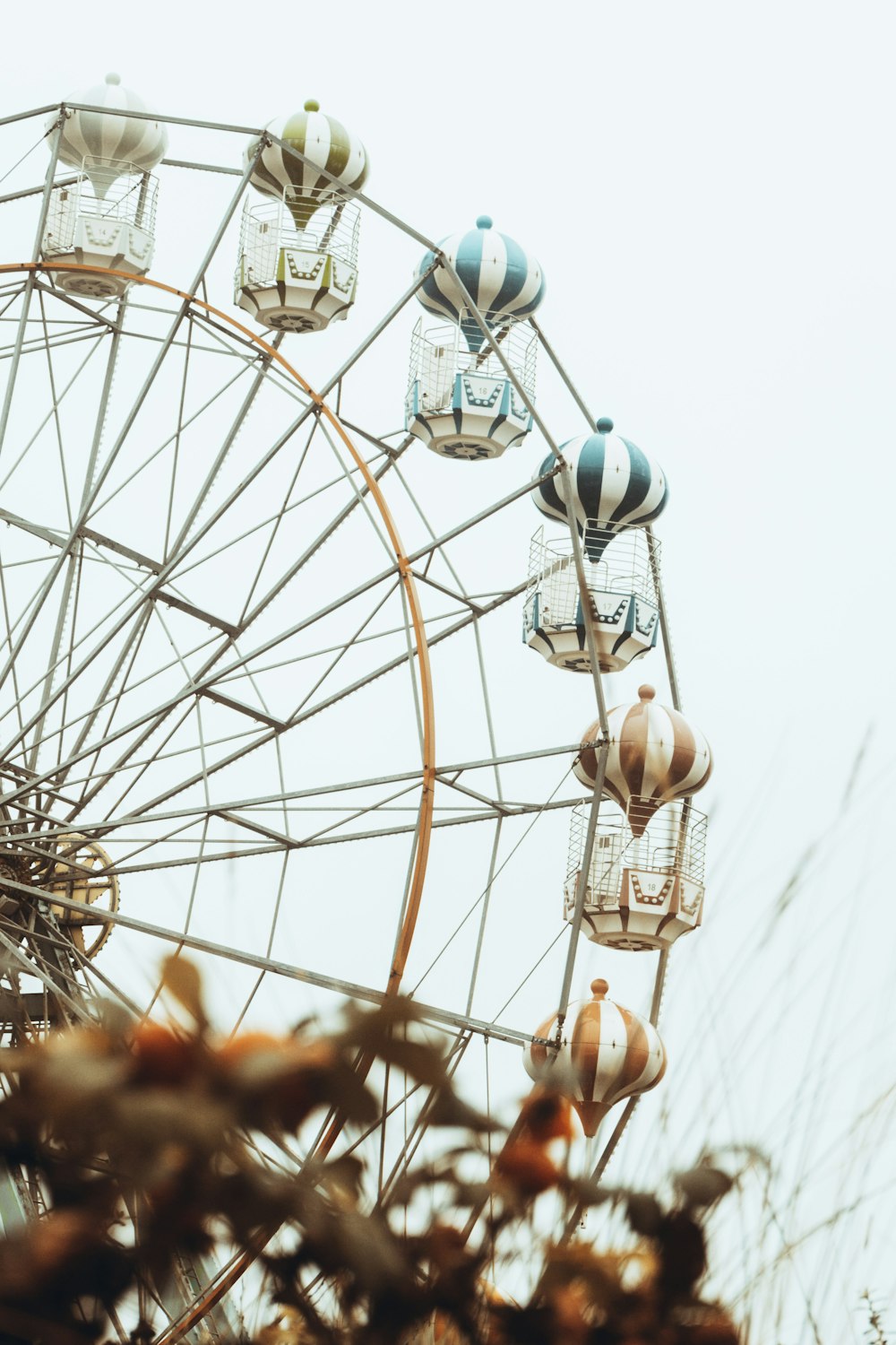 white ferris wheel under white sky during daytime