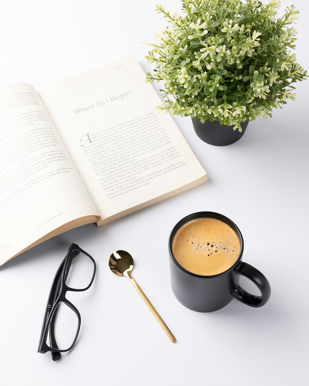 black ceramic mug beside white book page