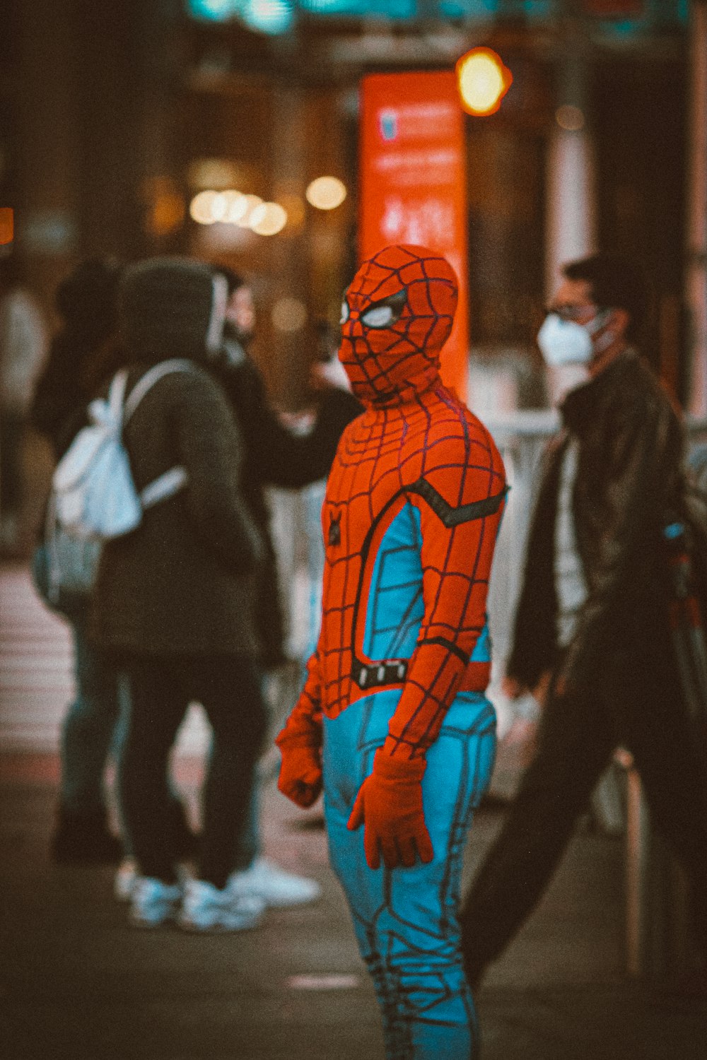 spider man costume standing on the street