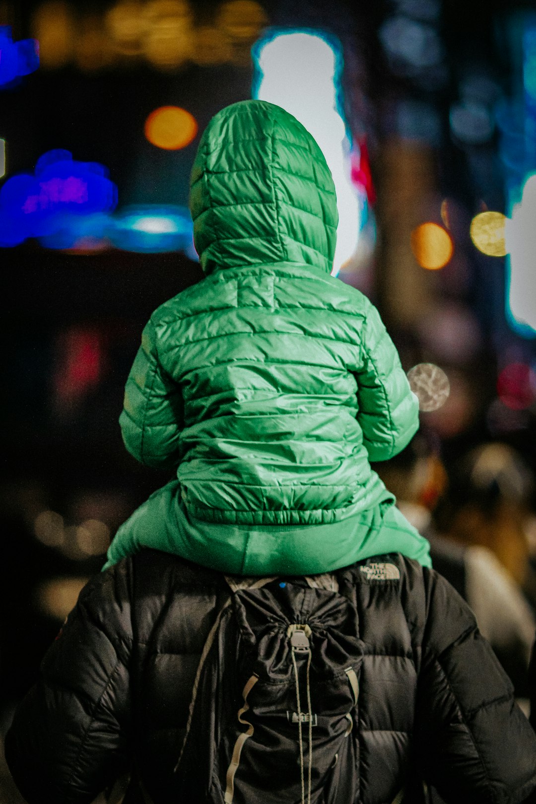 person in green hoodie and black pants