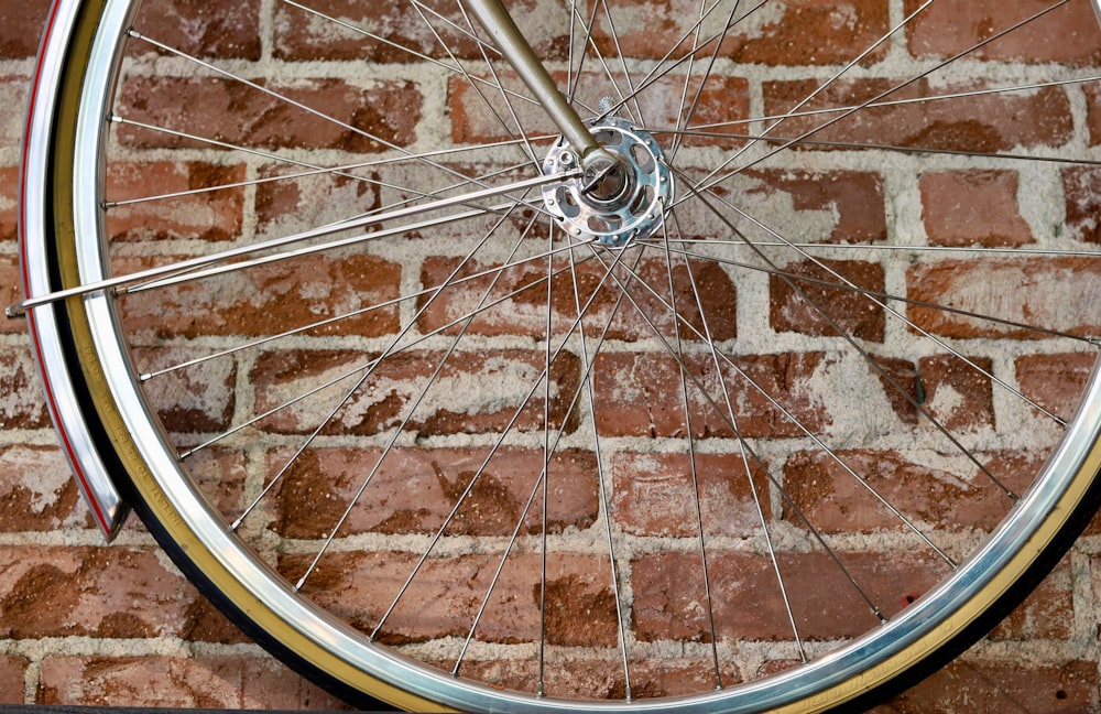 silver bicycle wheel on brown brick floor