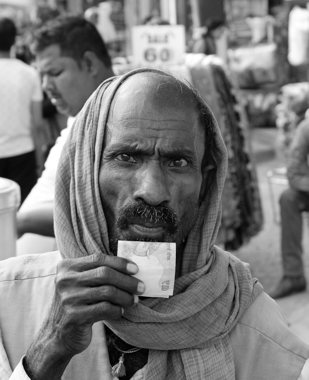 grayscale photo of man holding bottle