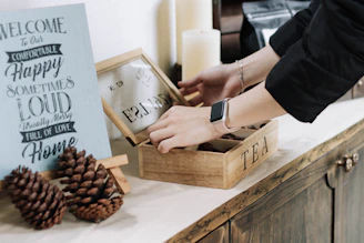 A delivery person handing over a neatly packaged nannusha tea box at a cozy home entrance.