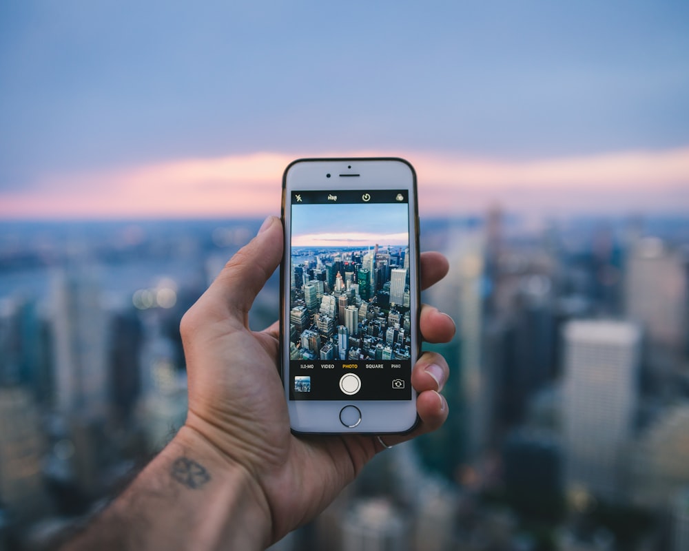 person holding silver iphone 6