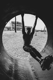man in black t-shirt and black pants jumping on air
