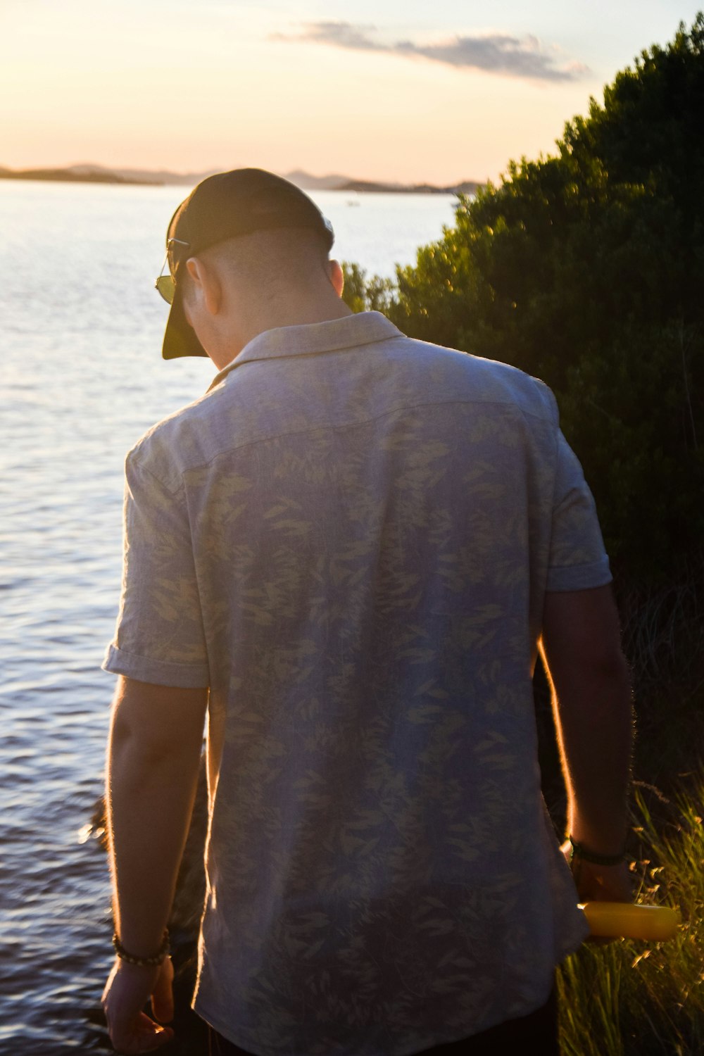 man in gray t-shirt standing near body of water during daytime