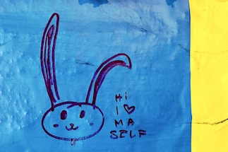 A cheerful illustration of Leo the lion and Alice waving hello beside a mailbox.