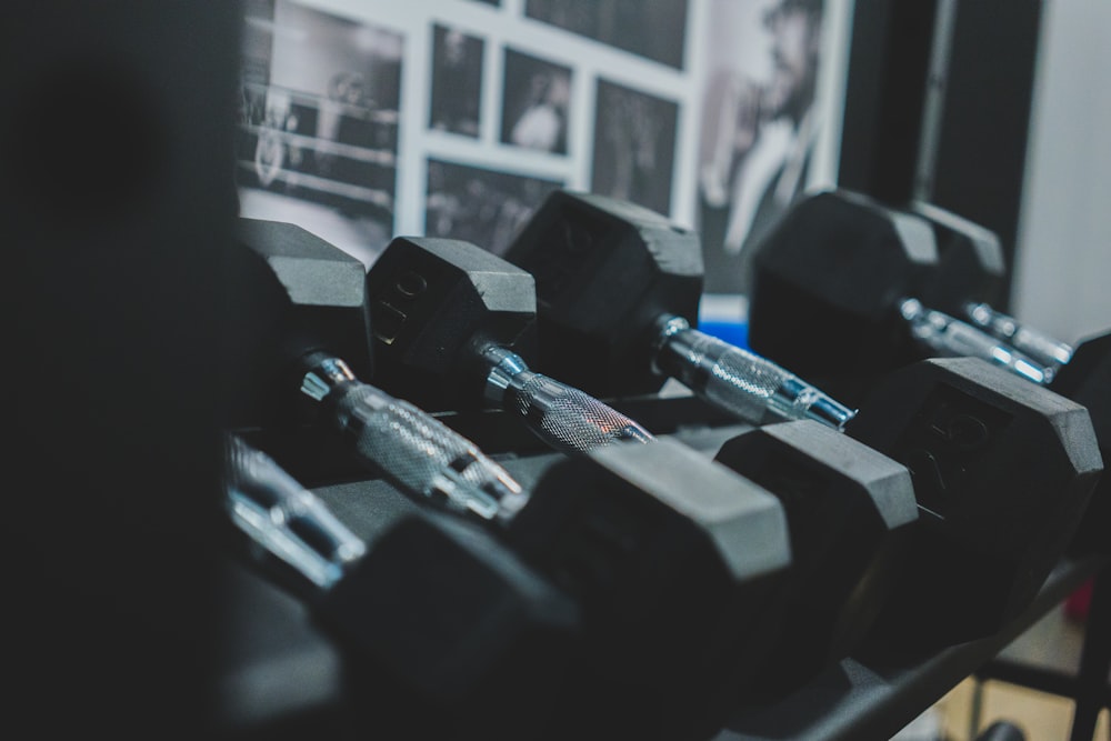 black and gray dumbbell on black and white textile