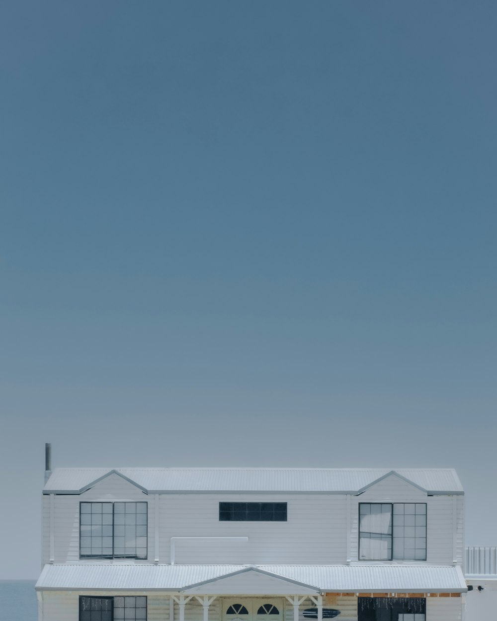 white and gray house under blue sky during daytime