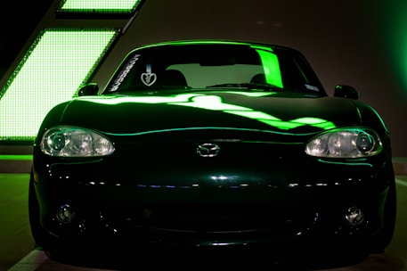 Minimalist black car interior featuring custom neon green accents.