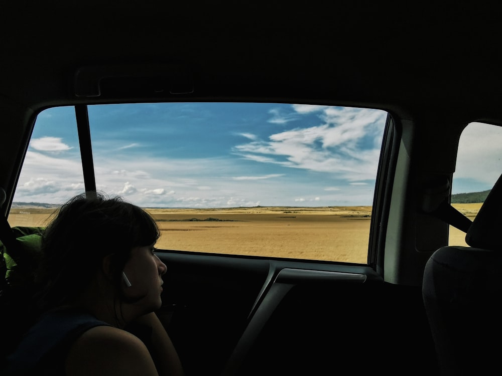 woman in black tank top sitting on car seat