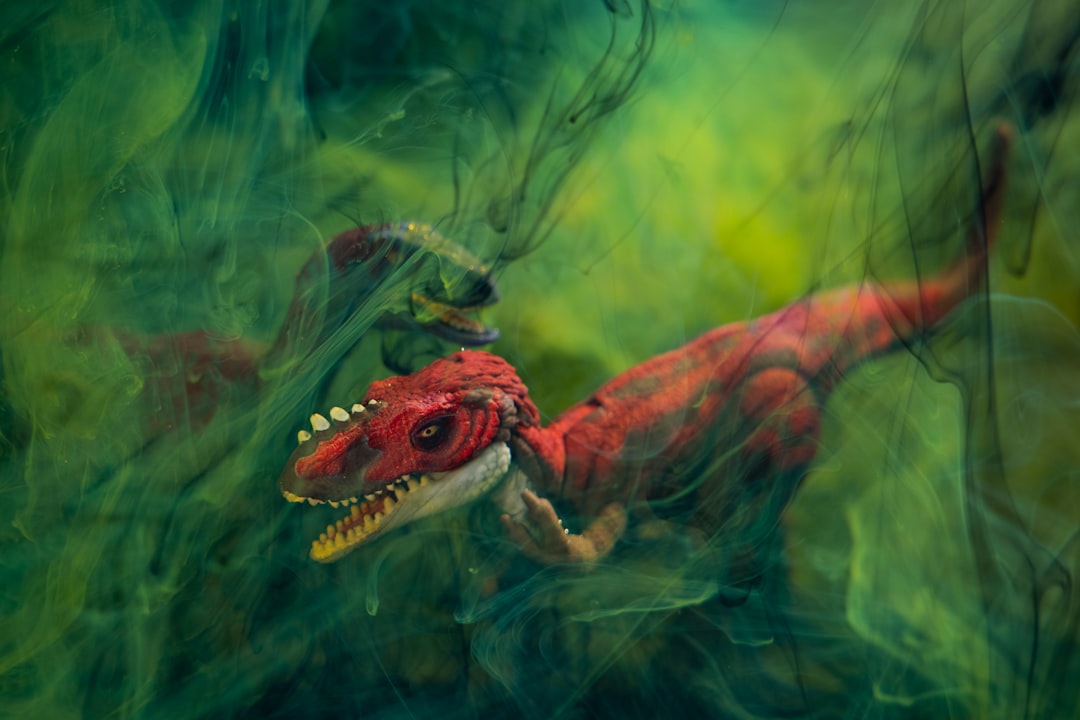 brown and green dragon in water