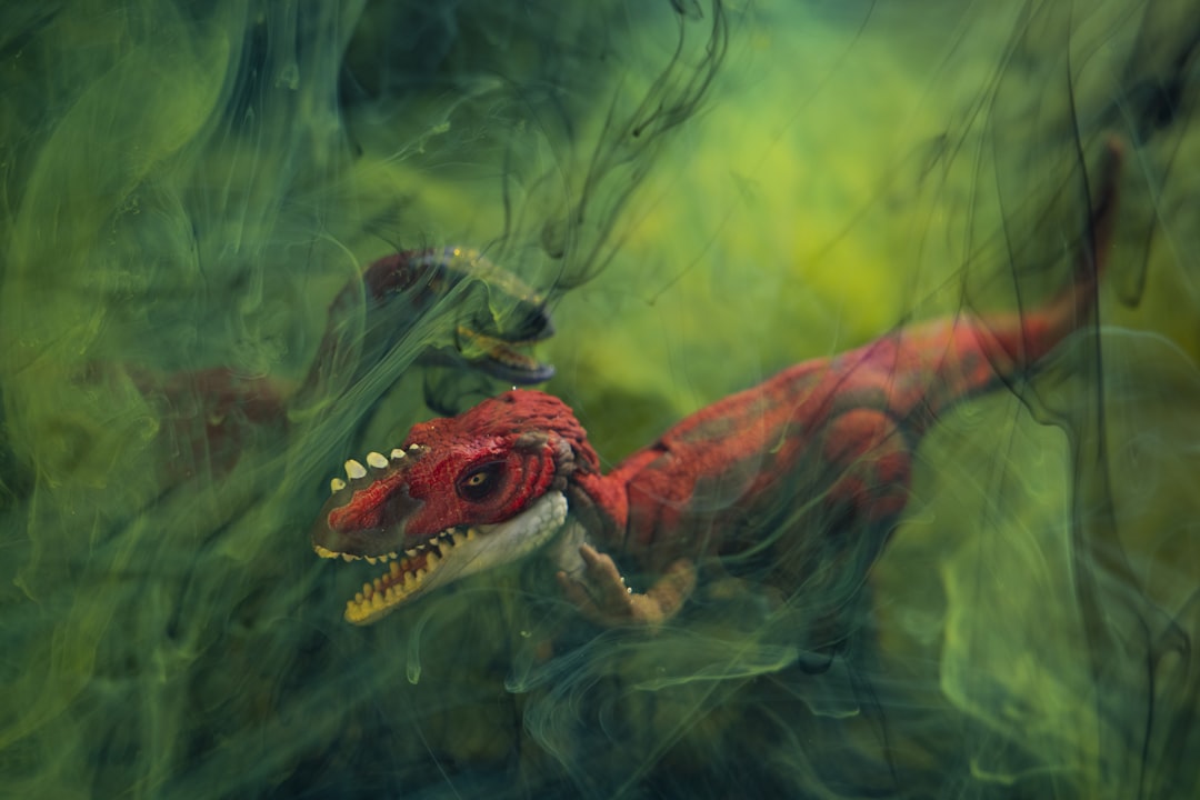 brown and green dragon in water, prehistoric dinosaur model