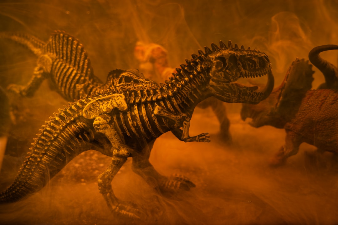 black and brown dinosaur toy, prehistoric dinosaur models