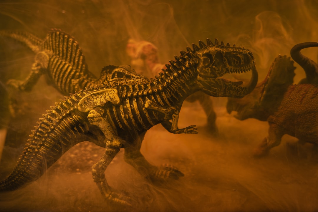 black and brown dinosaur toy, prehistoric dinosaur models
