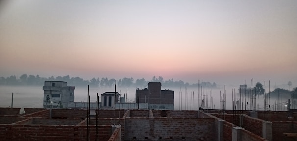 A calm dawn scene of a Korean urban civil engineering site with safety fences and signage.