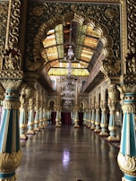 Grand event room featuring chandeliers and refined blue and gold tones.