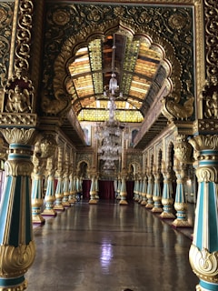 Grand event room featuring chandeliers and refined blue and gold tones.