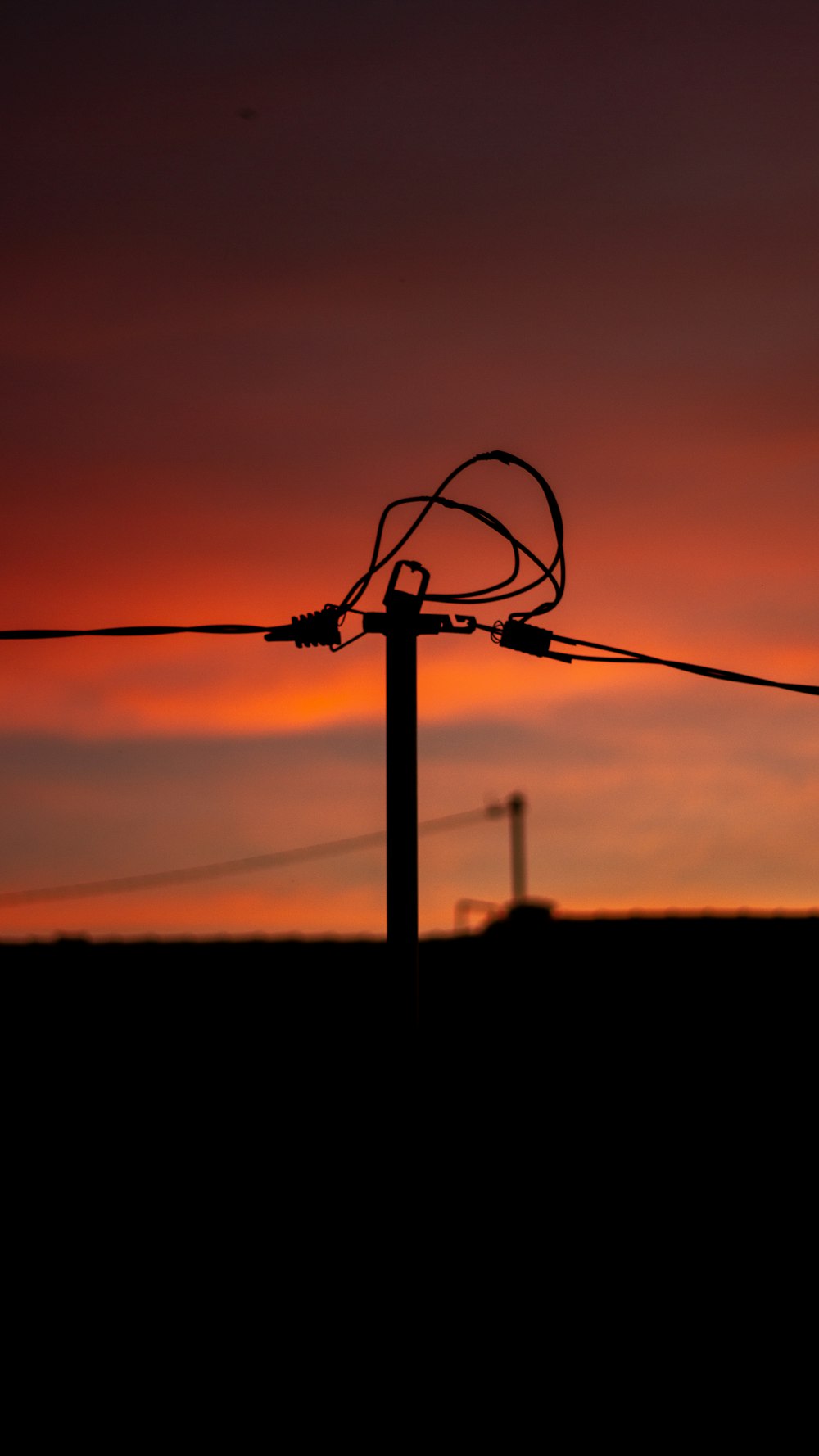 silhouette of a black wire during sunset