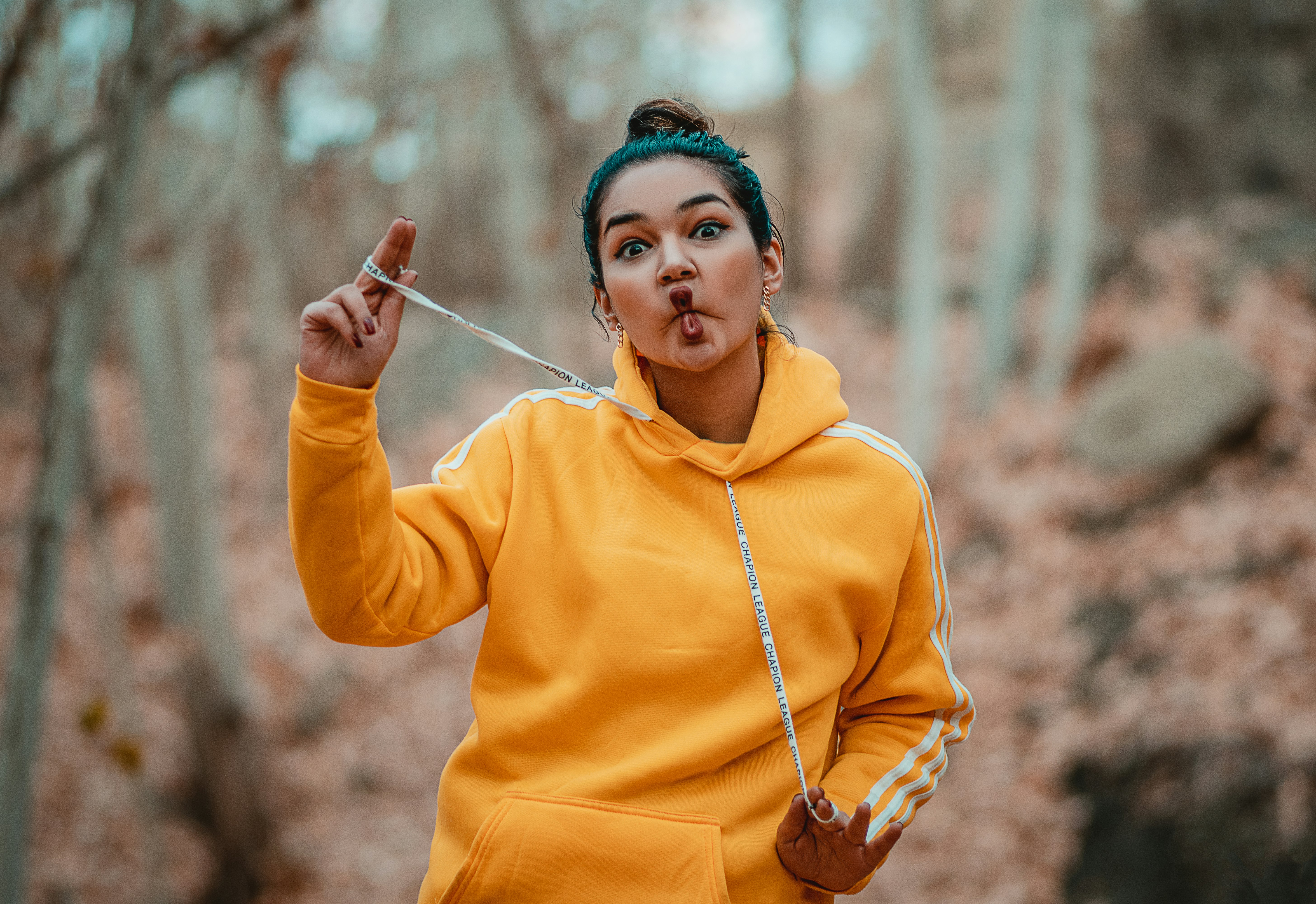woman in yellow hoodie holding stick