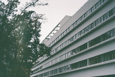 white concrete building during daytime constructivism teams background
