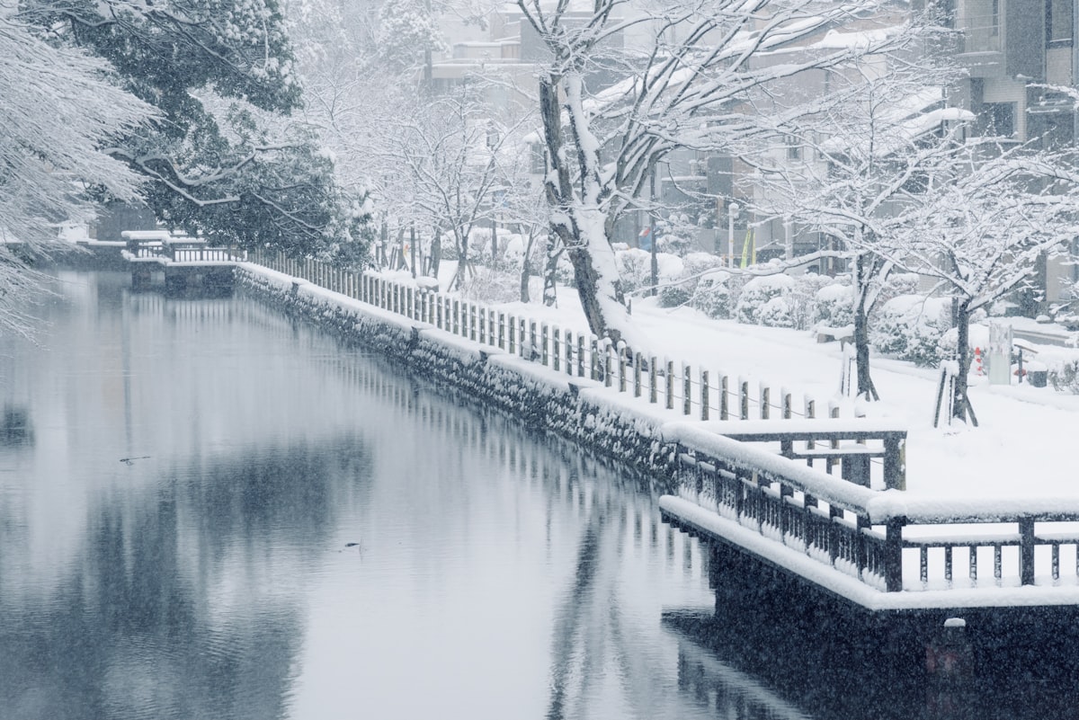 Kanazawa January — snow-covered canal and white fence in the historic district in deep winter