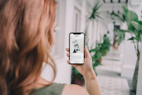 woman holding silver iphone 6