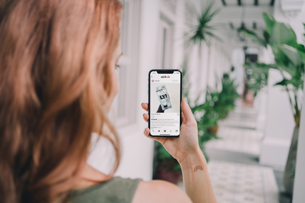 woman holding silver iphone 6