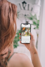 woman holding white samsung android smartphone