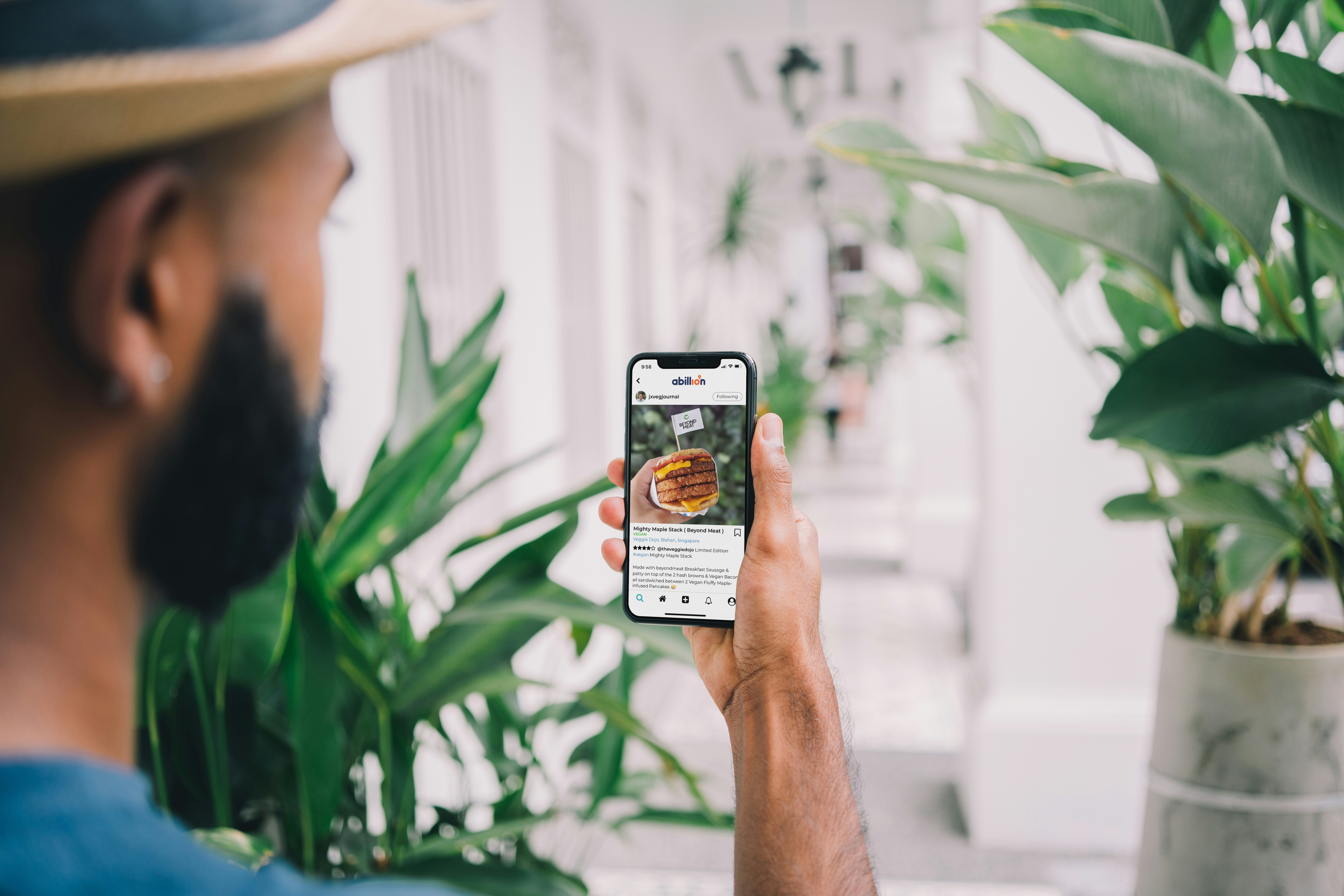 Man looking at a review of a Beyond Burger on the abillion app