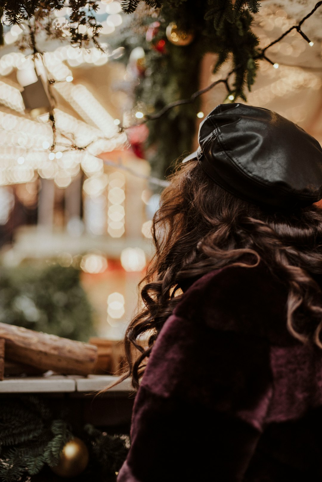 woman in black knit cap and purple coat