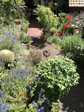An inviting garden with colorful flowers and a patio.