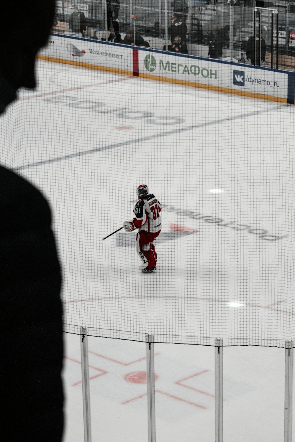 man in red and white hockey jersey shirt and black pants playing hockey